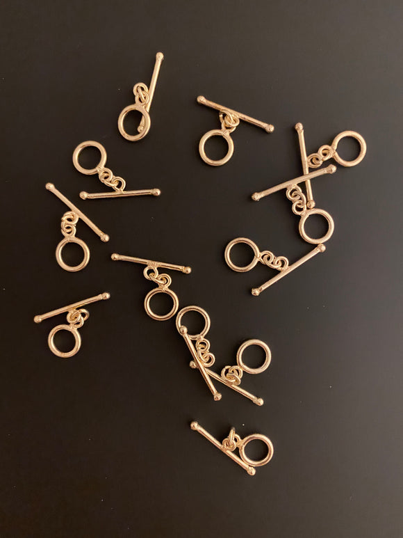 A Pack of 20 pieces of Decorated Toggles, E-Coated, Designer's Toggles 2 Colors Gold finish and Silver Plated.